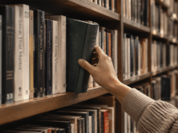 Picking a book in a bookshelf